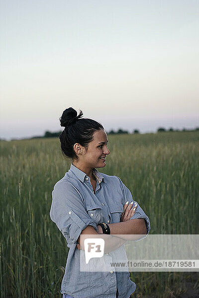 happy woman standing in the field and smiling