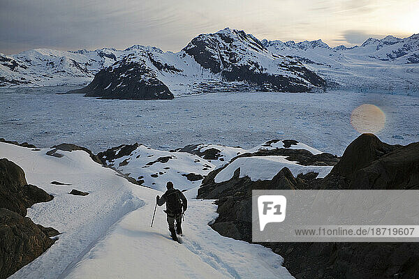 A glaciologist hikes down the Great Nunatak towards camp at the Columbia Glacier  near Valdez  Alaska.