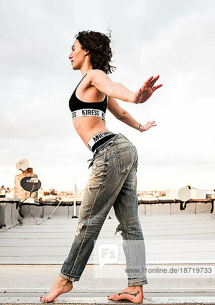 Young woman dances on Brooklyn rooftop