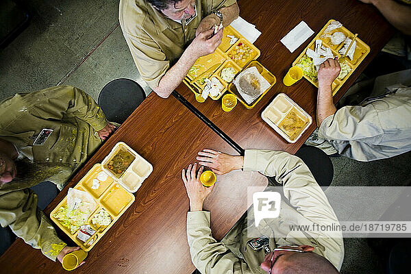 Inmates eat lunch.