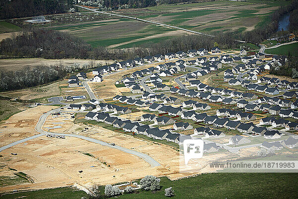 Aerial view of dense suburban housing development halted by the real estae bust and recession