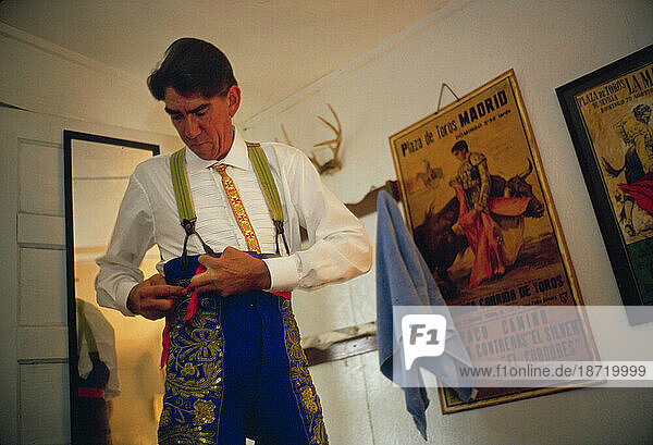 A matador dresses before the first Grand Corrida of the year.