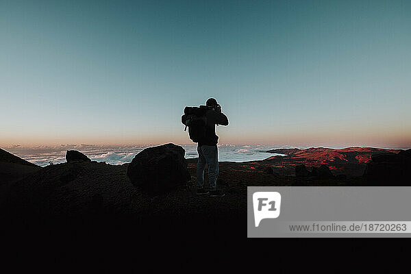A hiker take a photo at sunset in El Teide  Tenerife