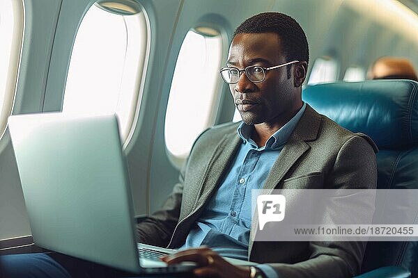 African business man working on laptop on a plane. Generative AI.
