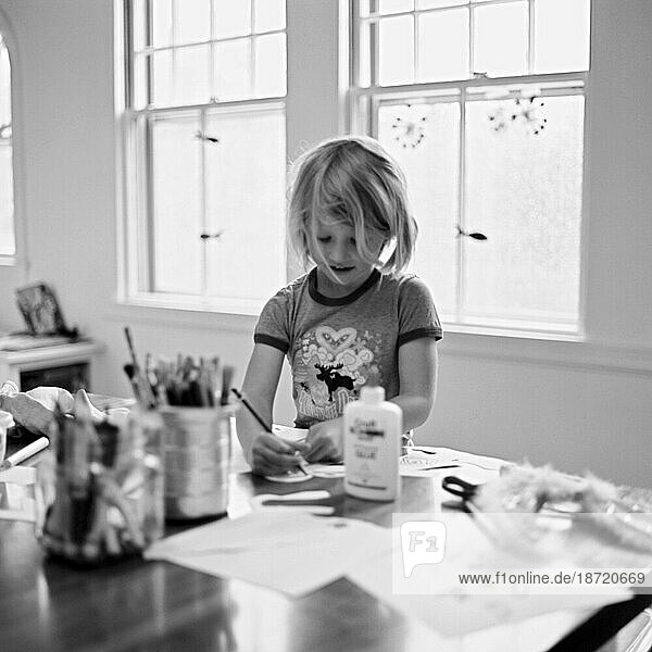 young girl busy with her artwork