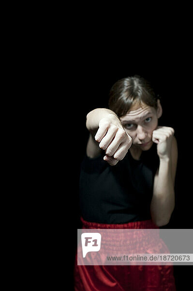 Portrait of female boxer throwing punch  Toronto  Ontario.
