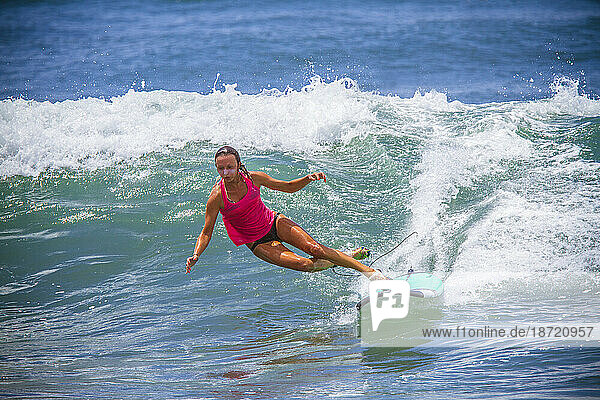 Surfer girl catches wave in high heels.