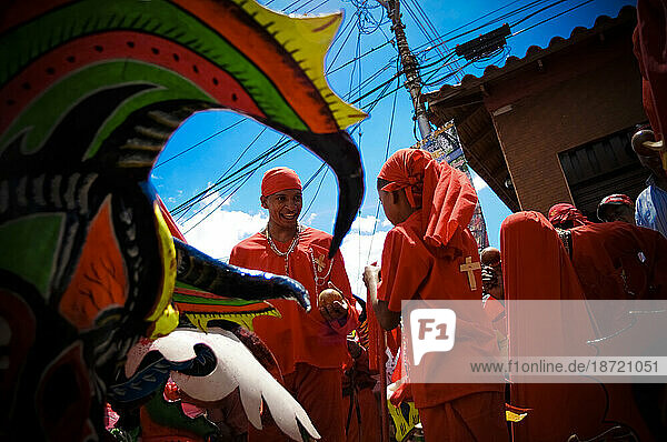 Young men dressed in red costumes celebrate a festival