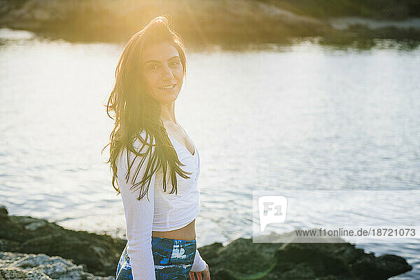 Candid Moment of Young Woman doing Yoga on the rocks at Golden Hour