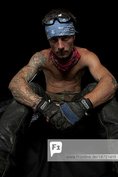 Motorcycle biker guy with tattoos and tough guy attitude