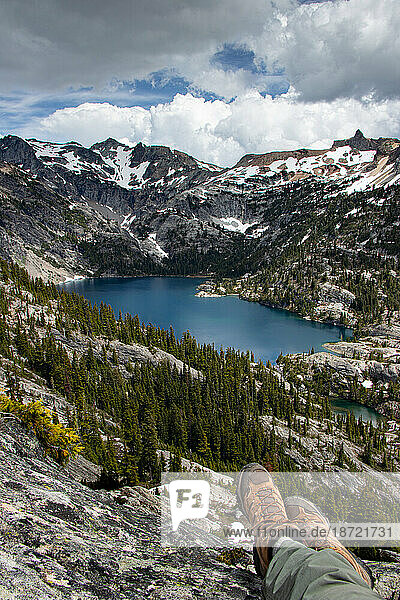 Hiker's boots perched high above Spade Lake in Alpine Lakes Wilderness