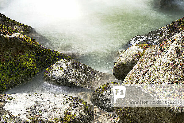 Closeup of Wet Mossy Rocks with water captured in a long exposure