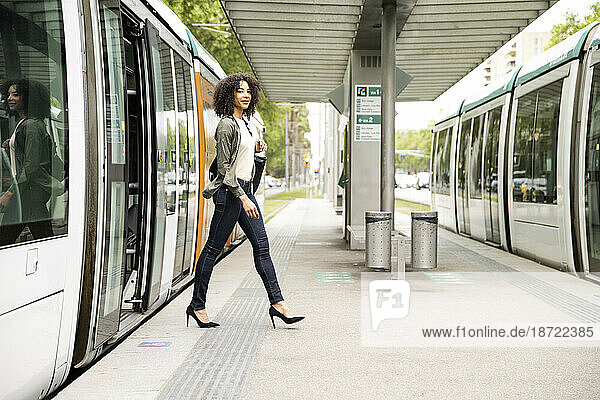 Young confident and relaxed woman commuting in city tram.