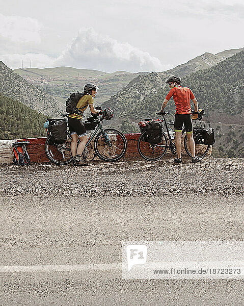 A couple of bike packers take a break while cycling through Morocco.
