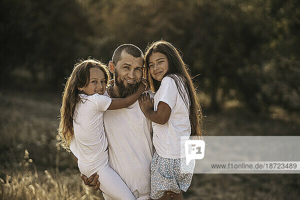 Daddy and two daughters   country life