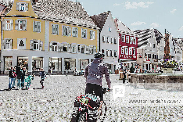 A man ride his bike with bikepacking in a square in Germany