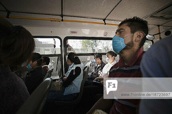People inside a bus wearing masks during the swine flu epidemic in Mexico City  DF  Mexico.