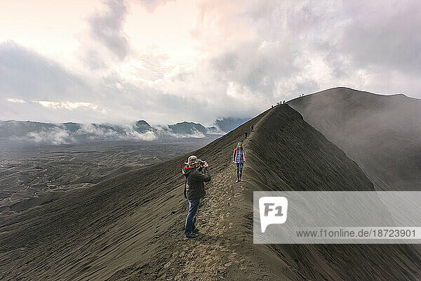 Hikers standing on top of the mountain and taking a pictures Java Indonesia.