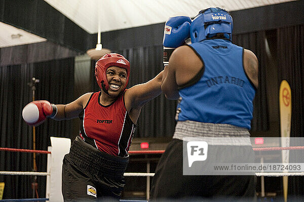 A female boxer lands a series of punches during a semi-final match at the Canadian Amateur Boxing Championships in Saint-Hyacinthe  Quebec.