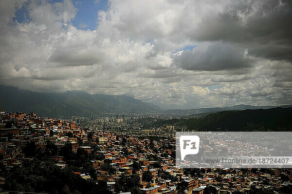 A sweeping cityscape of Caracas  Venezuela under a cloudy sky.