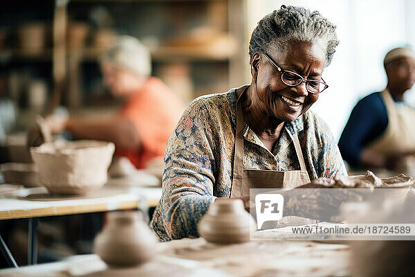 Smiling old african woman learning ceramics in a class. Generative AI.