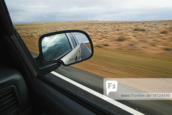 View of a vast plains landscape out of a car window driving somewhere near Hanksville  Utah.