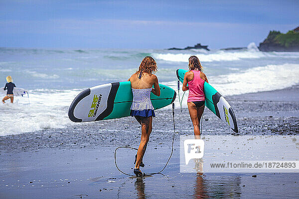 Surfer girls catch waves in high heels.