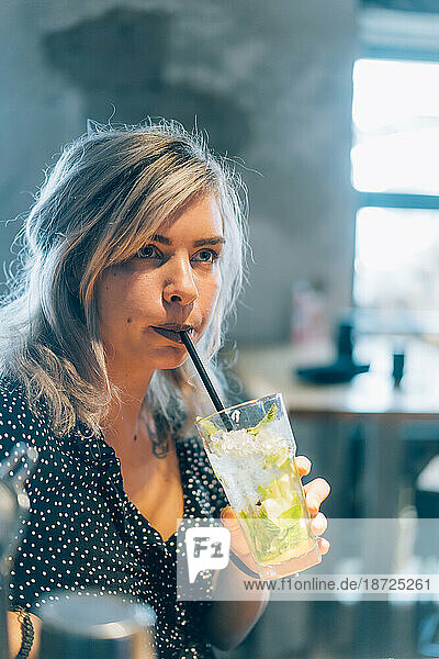 Girl Drinking A Mojito In A Cocktail Bar.