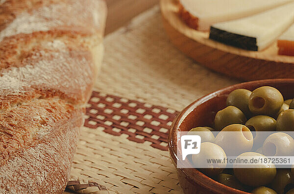 Delicious cheese board with rustic bread and olives