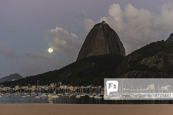 Beautiful landscape Sugar Loaf Mountain and full moon rising on clouds