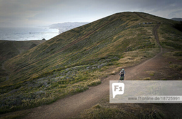 A mountain biker rides along a trail in Pacifica  CA.
