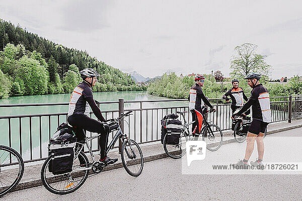 A group of cyclist resting in a river in the Romantische Strasse route