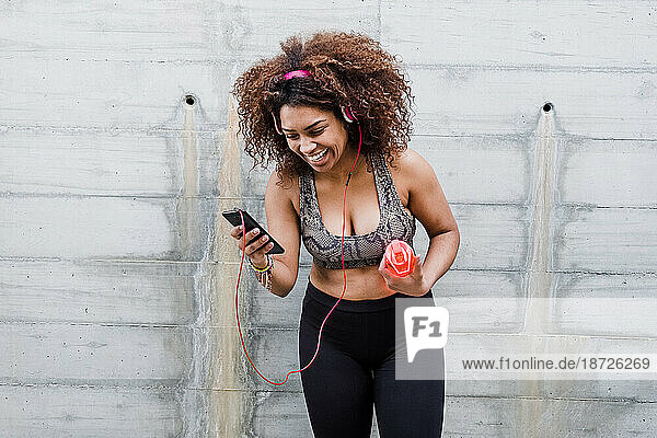 Happy Curvy African American Woman Working Out and Listening Music