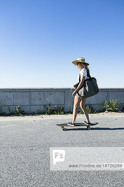 Woman skateboarding for a beach day in New England