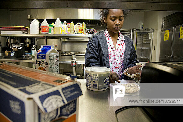 A homeless mother of four prepares breakfast for her children at Trinity Church in Sacramento  CA.