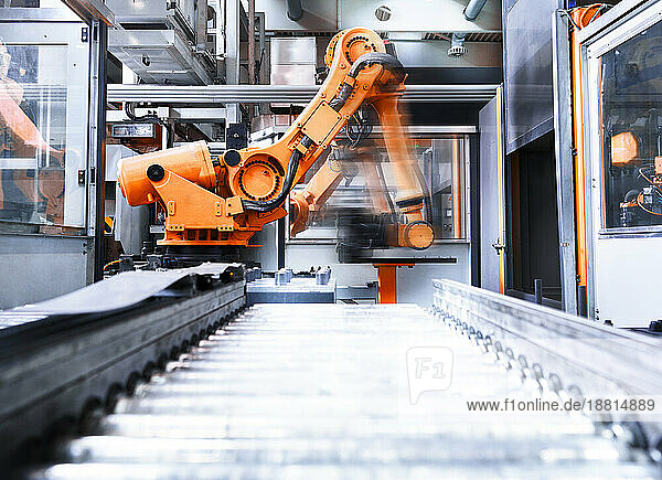 Blurred motion of robotic arm in factory
