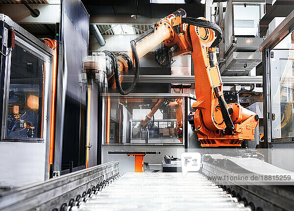 Robotic arm over production line in factory