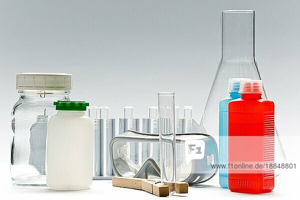 Verschiedene Chemiegläser  Flaschen und Gegenstände auf weißem Grund