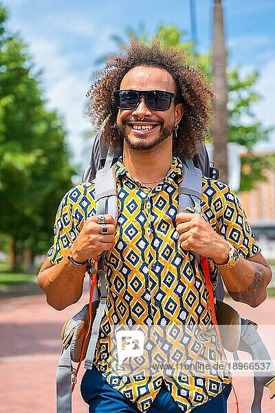 Porträt eines lächelnden Rucksacktouristen mit Afro Haar Mann im Sommerurlaub  Lebensstil außerhalb eines Touristen auf Reisen