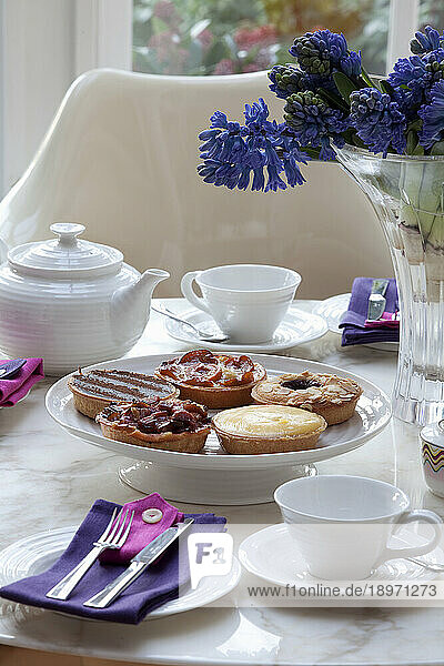 Tartlets for teatime on a white set tea table