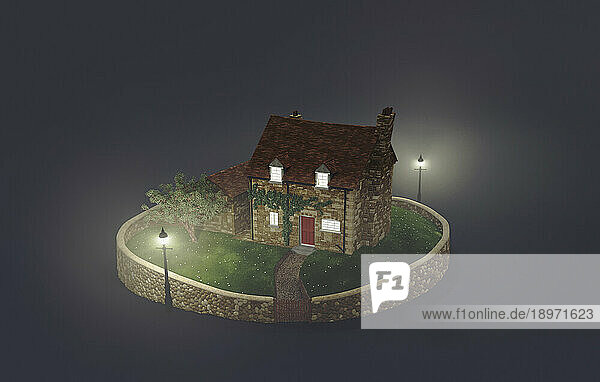 Stone cottage in fog at night
