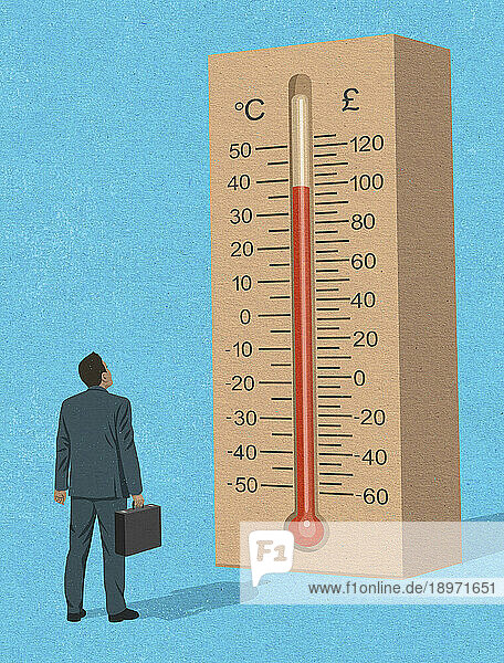Geschäftsmann schaut auf ein Pfund-Thermometer