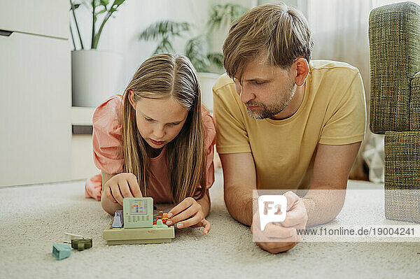 Father and daughter playing game at home