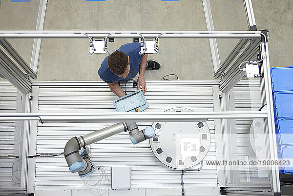 Engineer operating modern robotic equipment in industry
