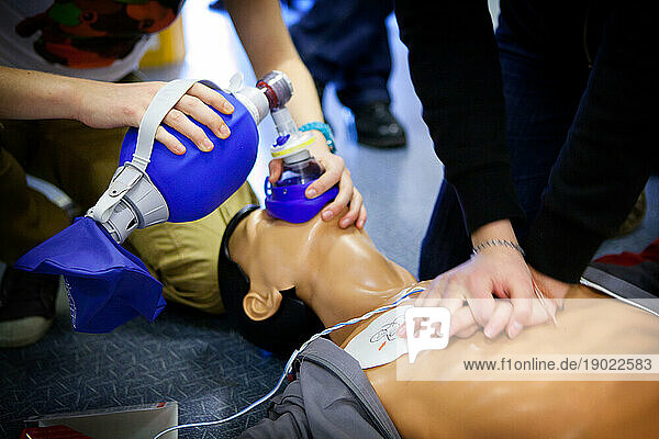 First aid training: alternate use of a manual resuscitator bag followed by cardiac massage.