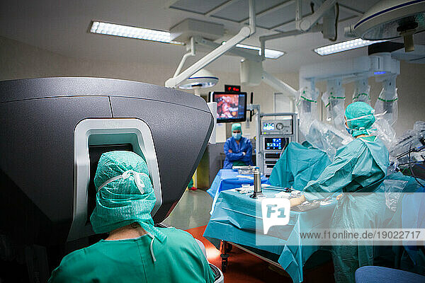 Robotic surgery in the operating room during a hysterectomy  the robot is driven by a surgeon from the console.