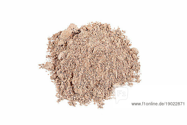 Heap of fine brown clay on white background.