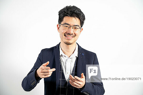 Portrait of Asian man talking and smiling.