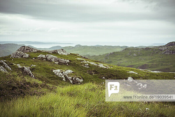 landscape scottish highlands ocean wild green grass and stone