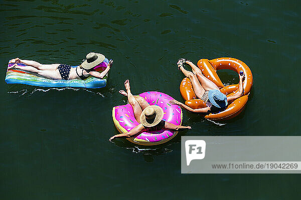 Three women floating in the Russian River.